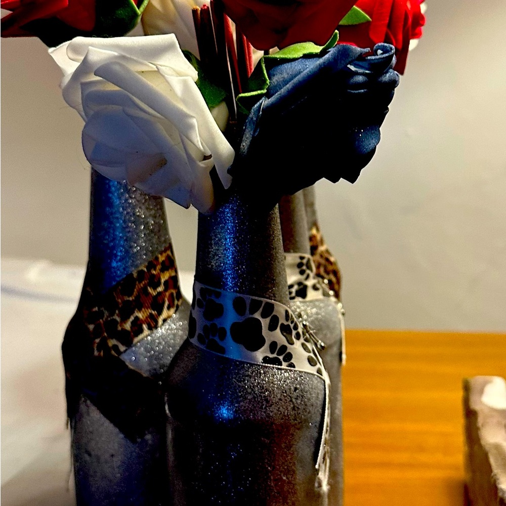 Homemade bottle decorated with glitter and flowers with incense in it